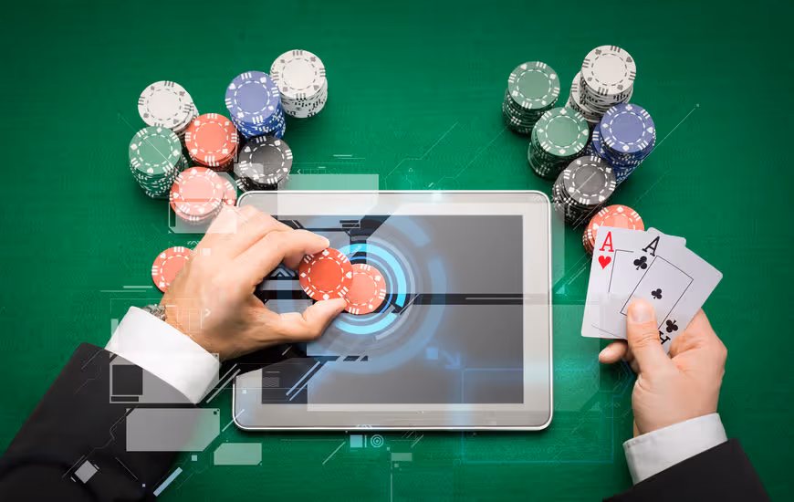 casino poker player with cards, tablet and chips