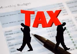 Income tax concept with silhouettes carrying the word 'TAX'