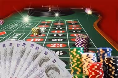 Roulette table with chips and British twenty-pound notes
