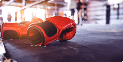 Red boxing gloves on a ring canvas