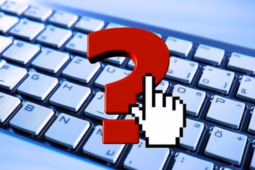 Mouse cursor clicking a question mark on a keyboard