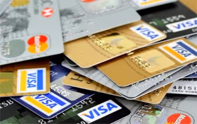 Pile of various Visa and Mastercard credit and debit cards