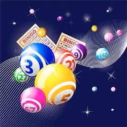 Colorful bingo balls and cards on a dark background with sparkles