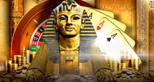 Egyptian-style statue with playing cards, a roulette wheel and gold coins