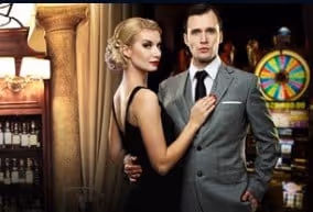 A stylish couple in a casino setting, with a roulette wheel in the background